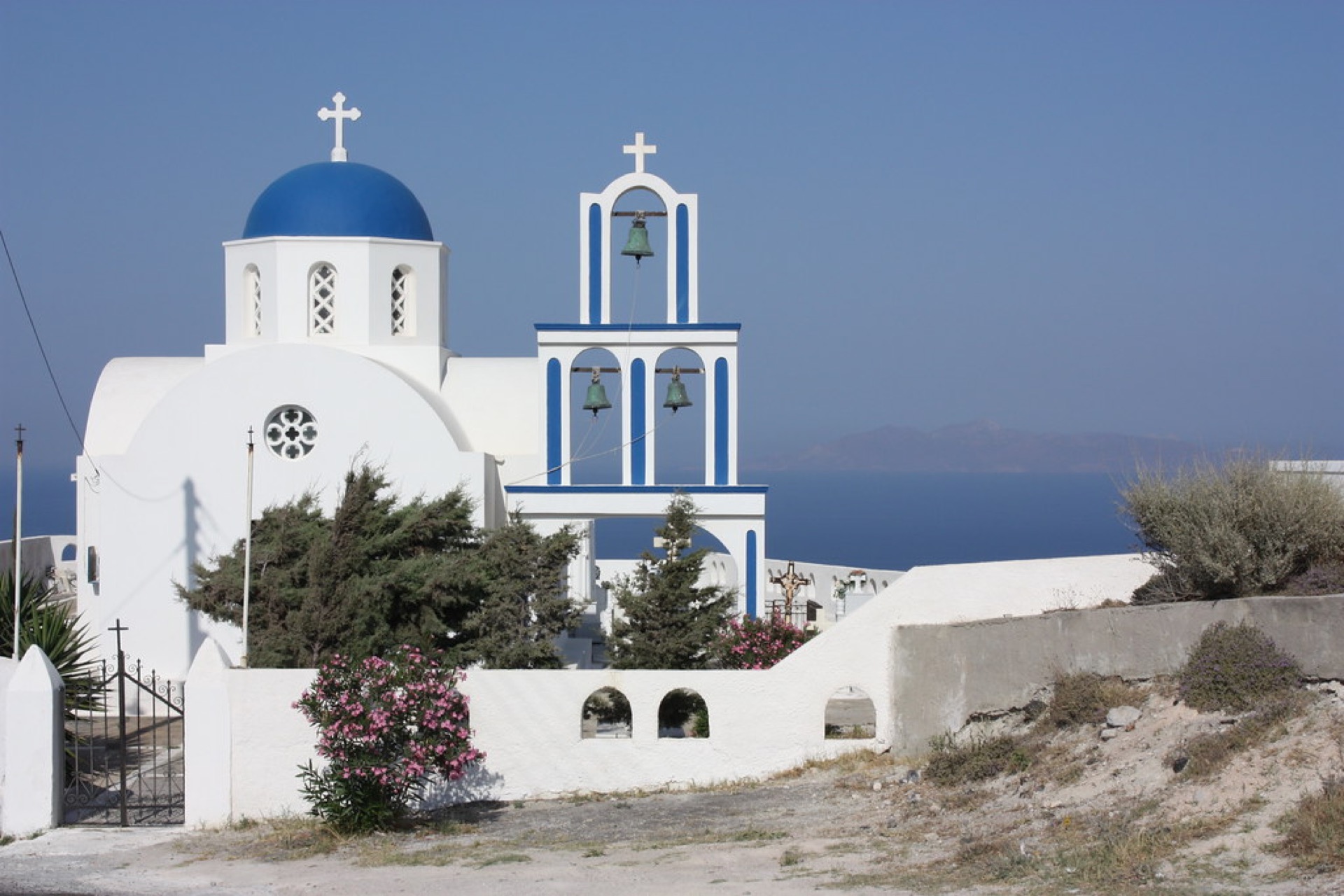 A blue-domed church above the Santorini caldera